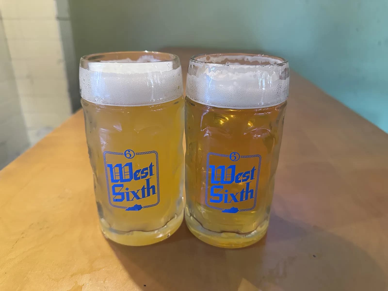 Two glass West Sixth Oktoberfest steins full of beer at the Lexington taproom